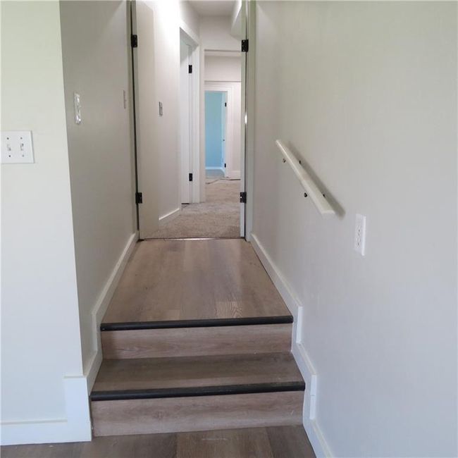 steps leading to primary bedroom | Image 16