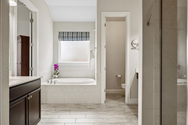 Full bath with a bath, vanity, a shower stall, and wood finished floors | Image 23