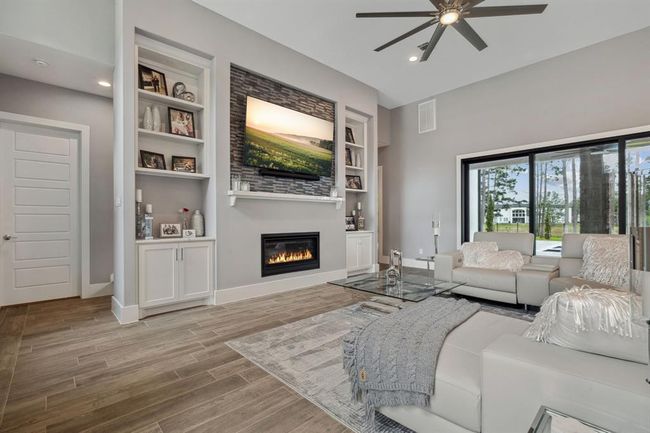 A cozy fireplace, set against a striking backdrop, adds both warmth and sophistication, blending a sense of homey comfort with luxurious elegance. | Image 10