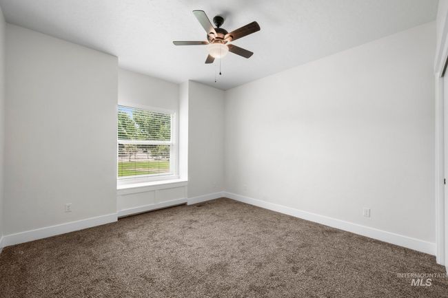 Carpeted spare room featuring baseboards and ceiling fan | Image 26