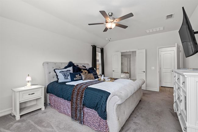 Bedroom featuring visible vents, baseboards, a ceiling fan, and light colored carpet | Image 16