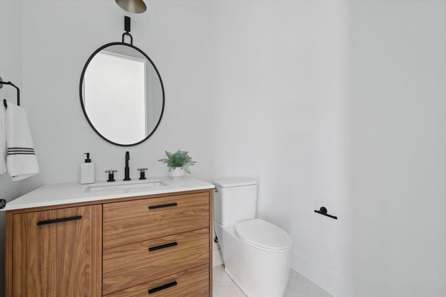 Half bathroom with baseboards, toilet, tile patterned flooring, and vanity | Image 26