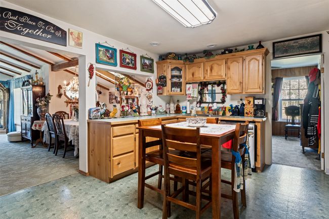 Kitchen with light countertops, light carpet, and light flooring | Image 21