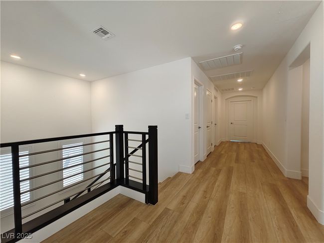 Hallway with recessed lighting, an upstairs landing, visible vents, and light wood-type flooring | Image 23