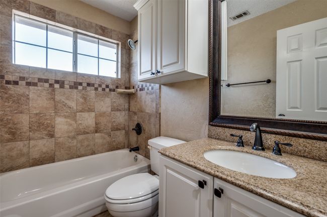 Full bathroom featuring a wealth of natural light, toilet, visible vents, and shower combination | Image 21