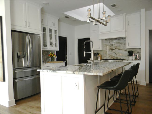 Kitchen with appliances with stainless steel finishes, stone countertops and backsplash, oversized kitchen sink and commercial faucet | Image 7