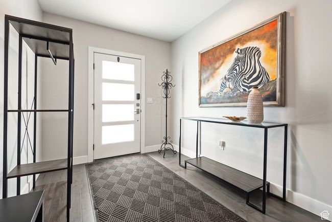 Entryway with dark wood finished floors and baseboards | Image 32