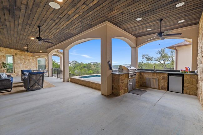 View of patio / terrace featuring a grill, an outdoor kitchen, a sink, and ceiling fan | Image 36