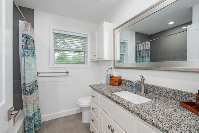 This is the second bathroom that has a spacious granite vanity and updates. | Image 22