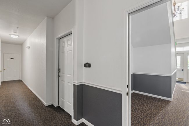 Condo 1B, with view of the condo's front door with the building's front door in the background, convenient access | Image 7
