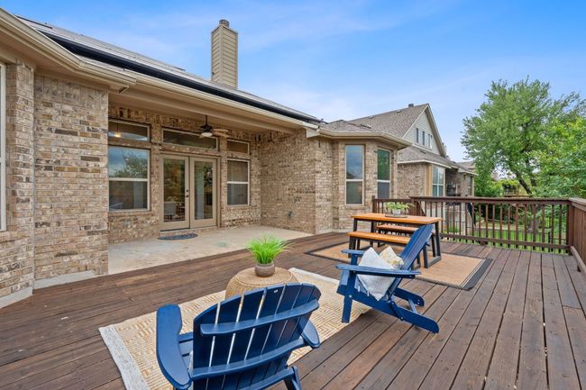 Covered patio featuring French doors, a ceiling fan, and an expansive deck | Image 30