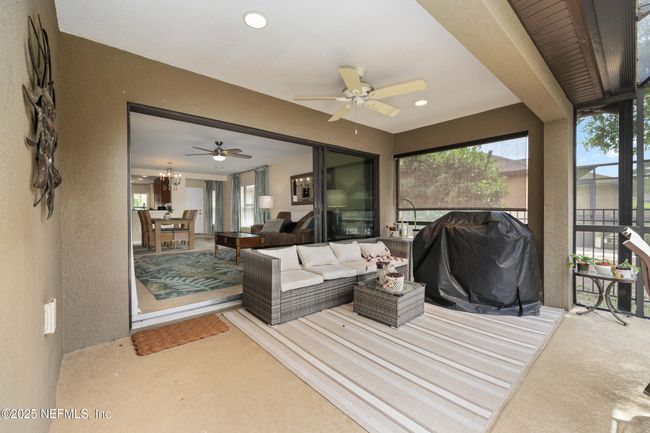 This private backyard lanai is screened to keep bugs out and features a roofed section for all-weather enjoyment. | Image 18