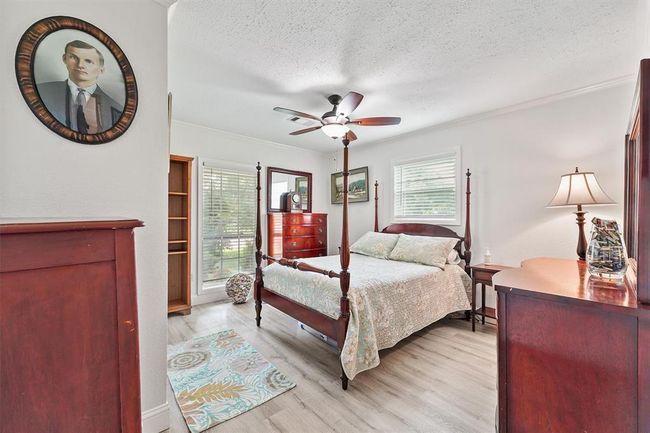 Bright and welcoming guest bedroom with large windows and neutral tones—ready for family, friends, or a cozy home office. | Image 10