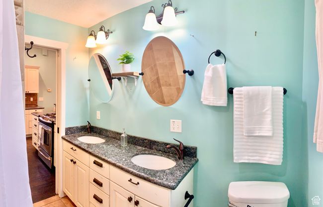 Bathroom featuring toilet, vanity, and tile patterned flooring | Image 9