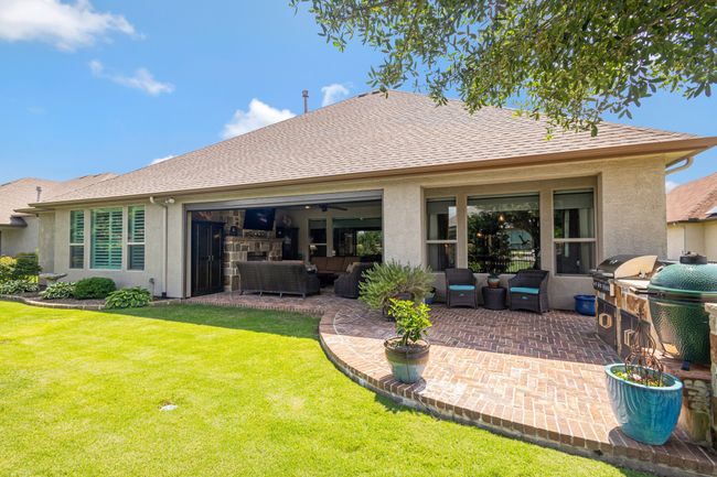Back of property with outdoor lounge area, a patio, a yard, and stucco siding | Image 32