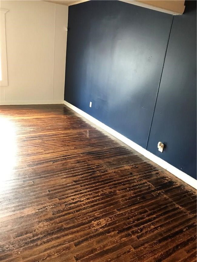 Unfurnished room with wood finished floors and baseboards | Image 7