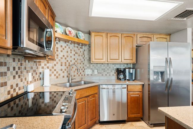 Stainless appliances with quartz countertops. Woodwork is beautiful and pictures do not do it justice. | Image 9