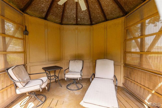 Unfurnished room featuring a decorative wall, hardwood / wood-style floors, and vaulted ceiling | Image 8