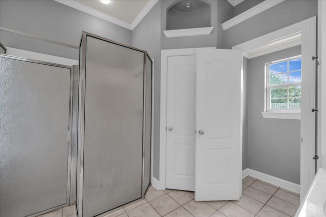 Full bathroom with ornamental molding, a stall shower, and tile patterned floors | Image 20