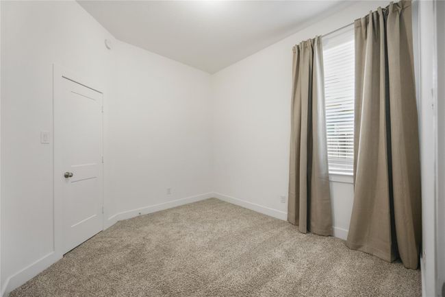 Bright and comfortable, Bedroom 2 is ideal for guests or family members, featuring ample closet space and a peaceful setting for rest or study. | Image 23