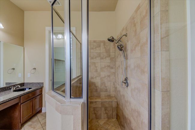 Primary Bathroom featuring a walk-in shower, tile patterned flooring, and dual vanity | Image 20