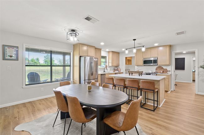 Dining space with light wood-style flooring and recessed lighting | Image 14