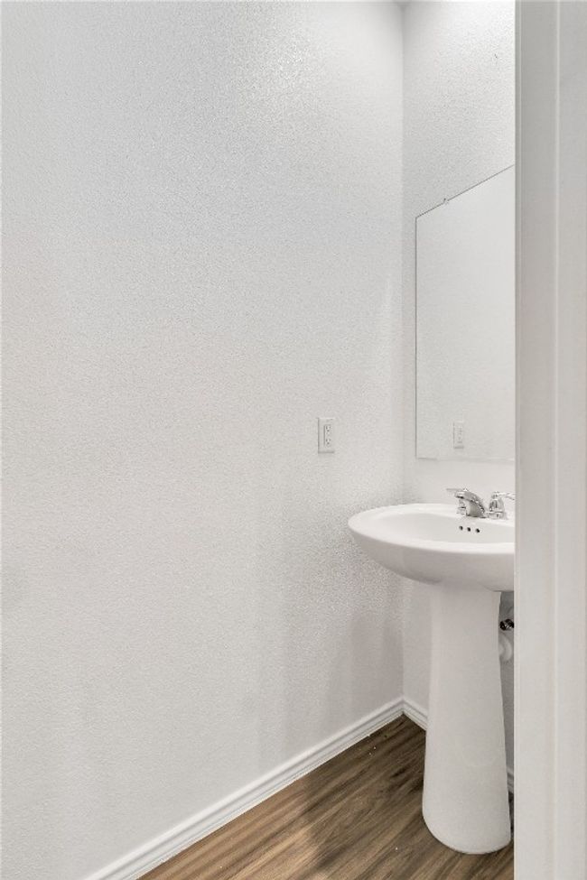Bathroom with baseboards and wood finished floors | Image 16