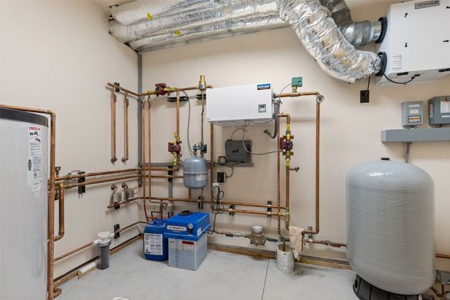 Mechanical room featuring electric boiler and water heater | Image 47