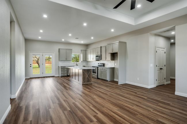 Kitchen with stainless steel appliances, visible vents, a ceiling fan, gray cabinetry, and dark wood-type flooring | Image 4