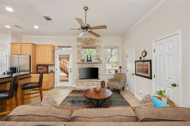 Centered by a stone fireplace the living area is light and airy and open. | Image 5