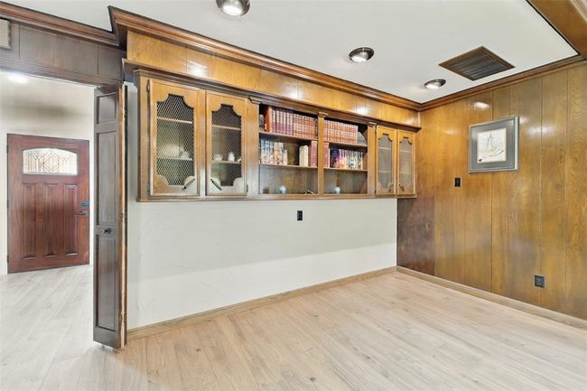 There is a sitting area and built-ins in the den. | Image 12