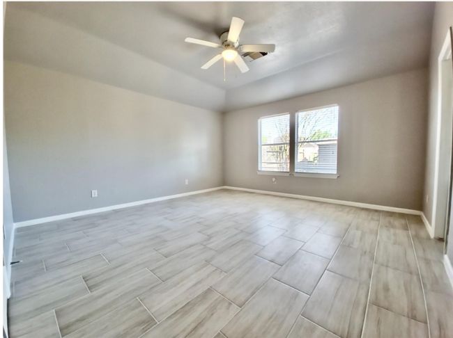 Empty room featuring ceiling fan and wood finish floors | Image 19