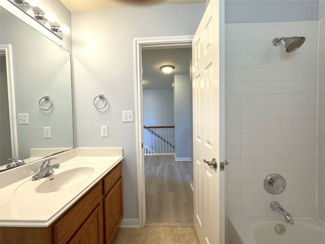 Full bathroom with vanity, shower combination, and tile patterned flooring | Image 12