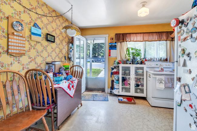 Kitchen with white appliances and wallpapered walls | Image 4
