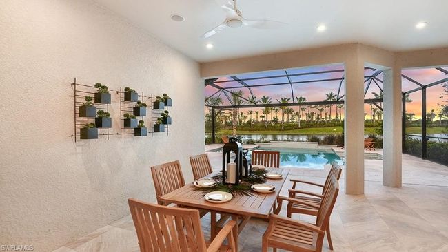 Dining room featuring recessed lighting, a water view, a ceiling fan, and a textured wall | Image 6