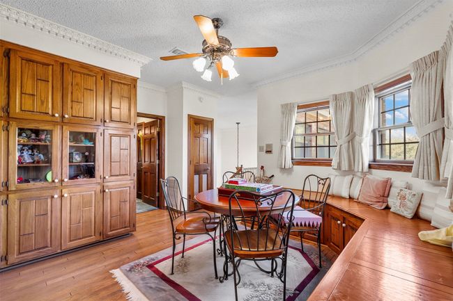 Dining area with ceiling fan, a textured ceiling, light hardwood / wood-style flooring, and crown molding | Image 24