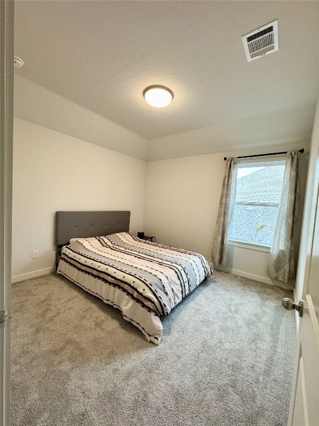 Carpeted bedroom featuring baseboards | Image 6
