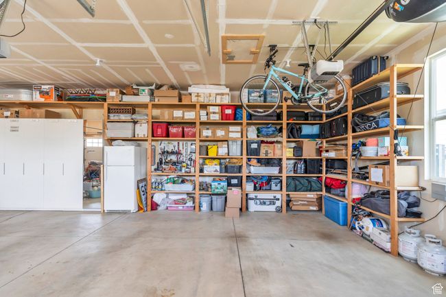 Garage featuring freestanding refrigerator | Image 78