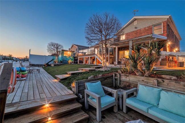 Wooden deck featuring a lawn and stairway | Image 31