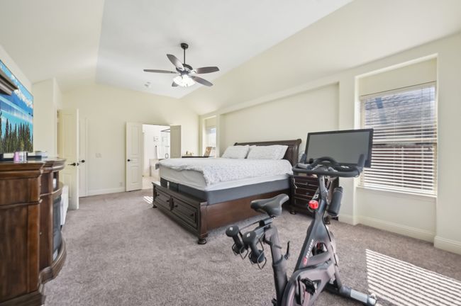 Bedroom with carpet floors, baseboards, a ceiling fan, and lofted ceiling | Image 22