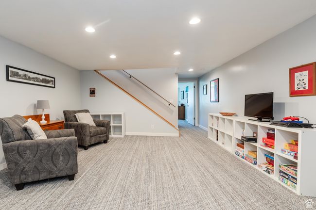 Carpeted living room with baseboards, recessed lighting, and stairs | Image 25
