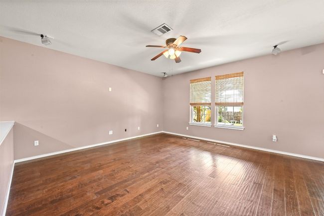 Spare room featuring ceiling fan and wood finished floors | Image 8