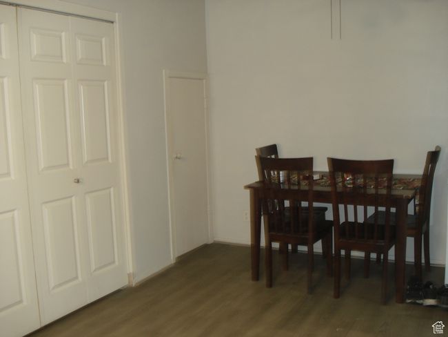 Dining area featuring wood finished floors and hidden pantry, washer and dryer area | Image 18