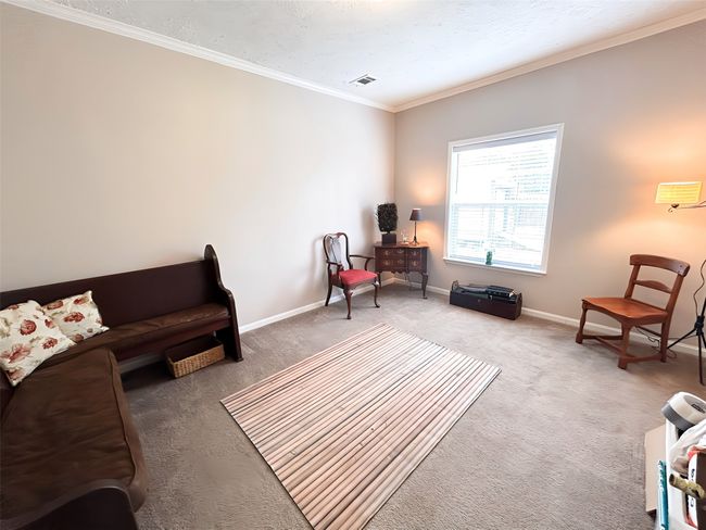 Living area featuring ornamental molding, baseboards, a textured ceiling, carpet floors, and visible vents | Image 21