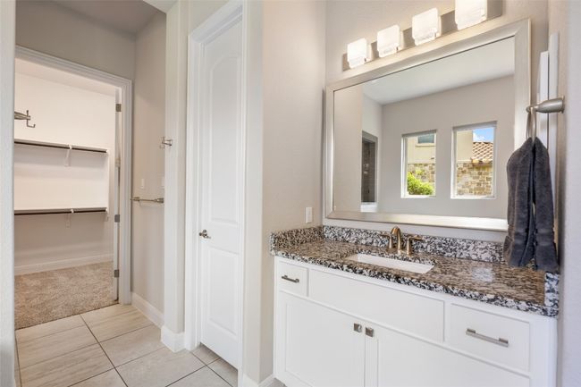 Bathroom featuring vanity, tile patterned floors, and a walk in closet | Image 20