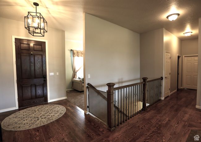 Foyer featuring a chandelier, wood finished floors, and baseboards | Image 20