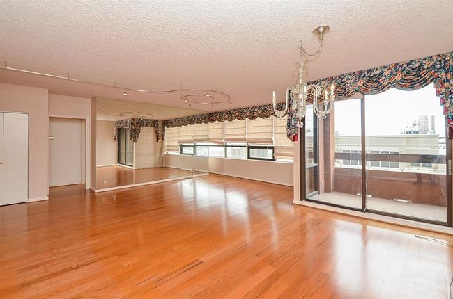 This 8th-floor residence boasts stunning North and West views, with a spacious 40-foot-long open-concept living and dining area that flows seamlessly into the kitchen. | Image 6