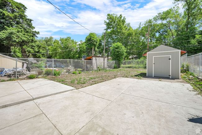 Fenced backyard with a patio area | Image 19