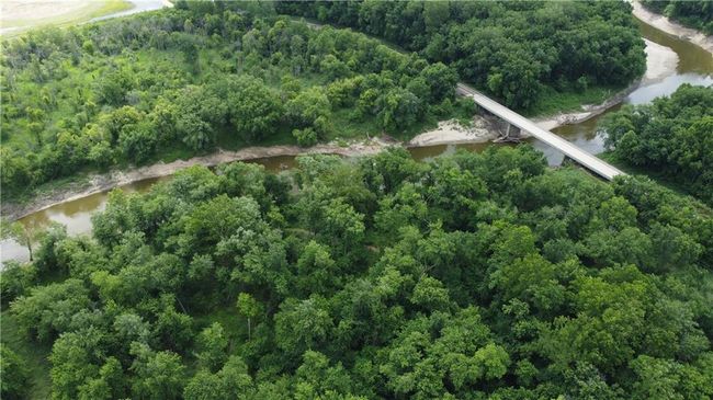 Aerial view of property's location featuring a large body of water and a heavily wooded area | Image 55