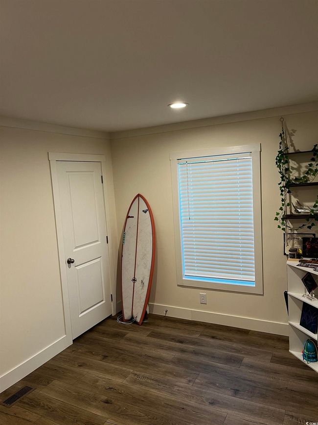 Empty room featuring dark wood finished floors and recessed lighting | Image 15
